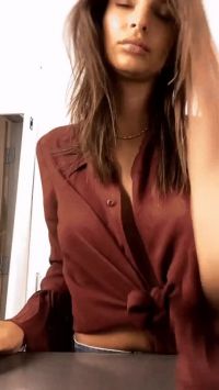 Emily Ratajkowski Adjusting Her Top