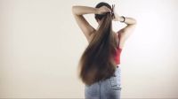 Beautiful Brunette Tying Her Ponytail